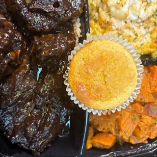 Oxtail Plate served with Yams mac N' Cheese and cornbread